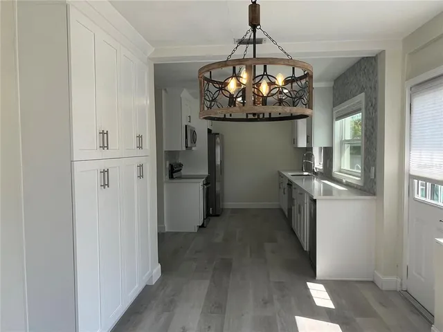 a kitchen with refrigerator and cabinets
