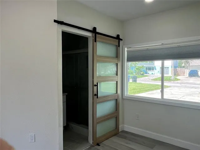 a bathroom view of a toilet and a hardwood