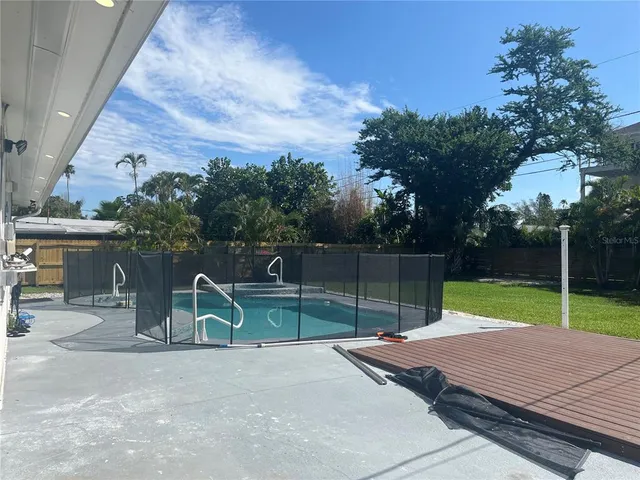 a view of a yard with swimming pool