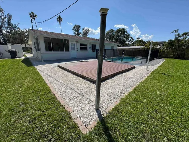 a view of a yard with wooden fence