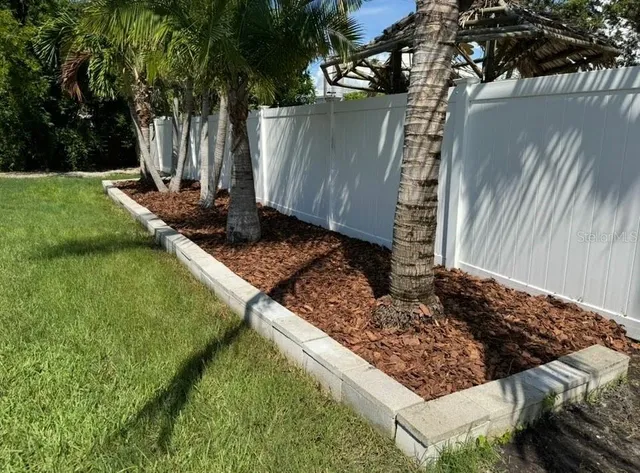a view of a backyard with sitting area