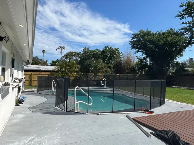 a view of a room with a window wooden floor and chandelier