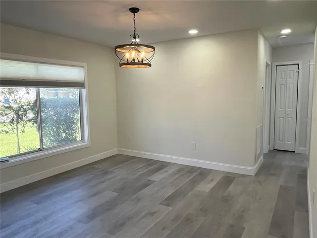 a kitchen with stainless steel appliances granite countertop a sink and a refrigerator