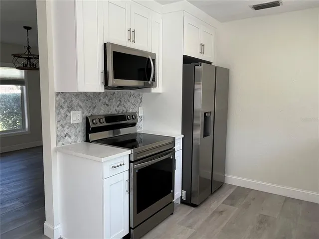 a kitchen with stainless steel appliances a stove and a refrigerator