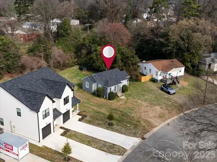 an aerial view of a house with a yard