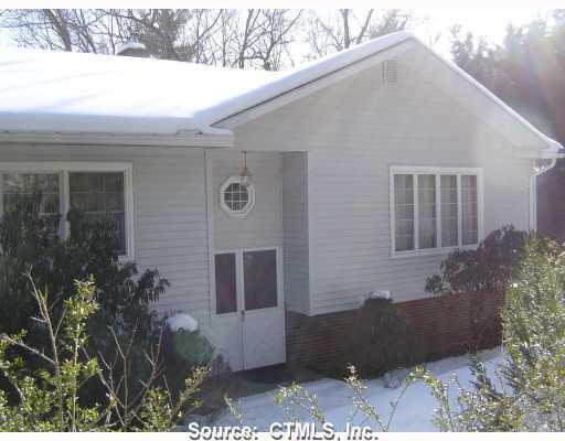 136 Woodward Road Brooklyn, CT 06234 - Photo 1 of 1 a backyard of a house with outdoor seating