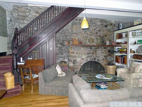 27 Vernon Road Copake, NY 12516 - Photo 2 of 10 a living room with furniture and a fireplace