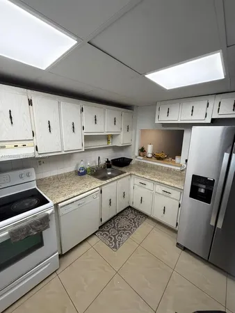a kitchen with cabinets and appliances