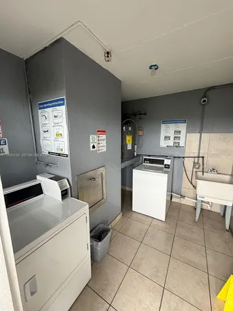 a kitchen with a sink a stove and a refrigerator