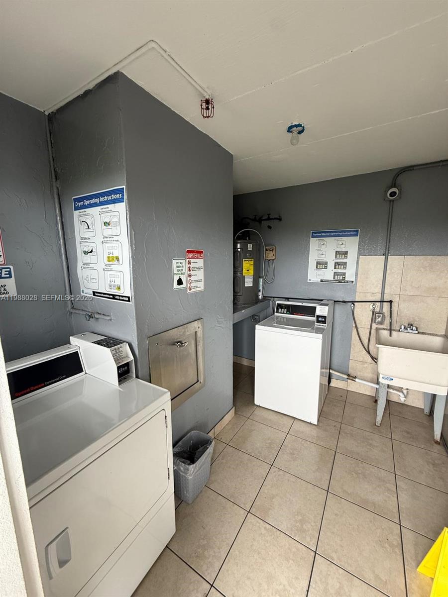 220 Southwest 9th Avenue, Unit 516 Hallandale Beach, FL 33009 - Photo 14 of 14 a kitchen with a sink a stove and a refrigerator