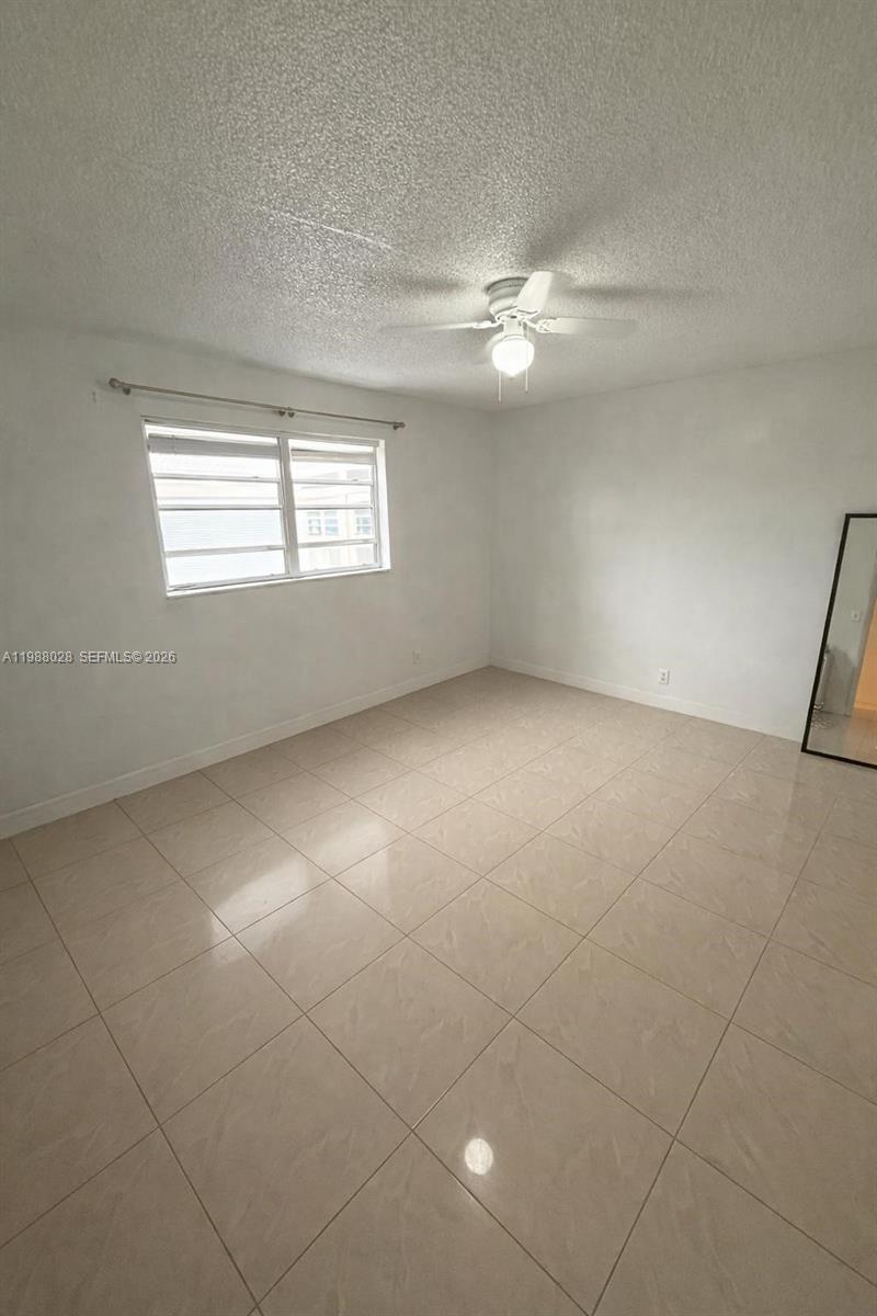 220 Southwest 9th Avenue, Unit 516 Hallandale Beach, FL 33009 - Photo 4 of 14 a view of an empty room with a window