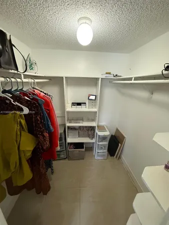 a bedroom with a bed and a chair