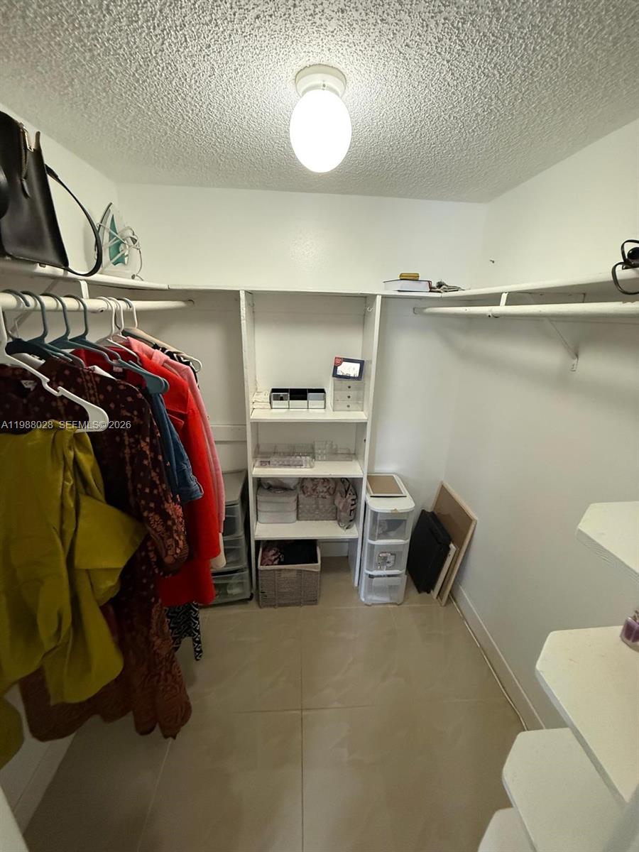 220 Southwest 9th Avenue, Unit 516 Hallandale Beach, FL 33009 - Photo 5 of 14 a bedroom with a bed and a chair