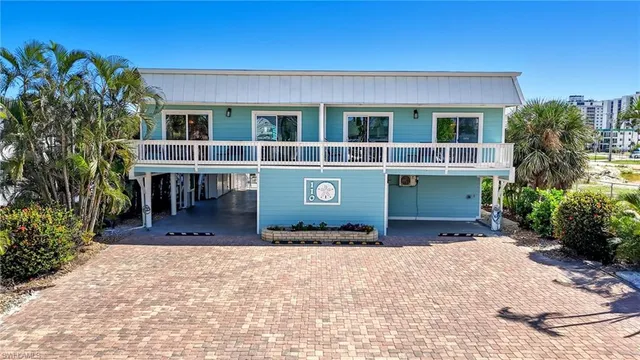 a living room with furniture a view of kitchen and a window