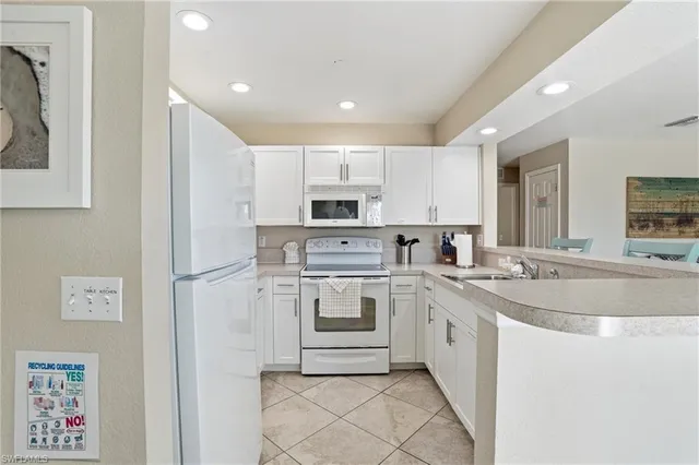 a dining room with furniture a chandelier and a rug
