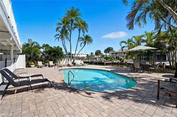 a view of a house with backyard sitting area and garden