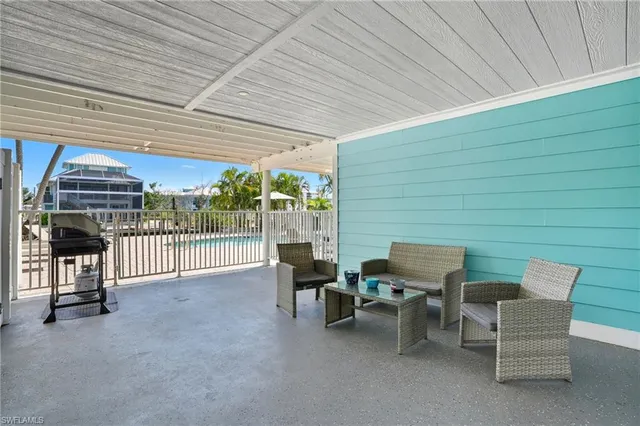 a swimming pool with outdoor seating and yard