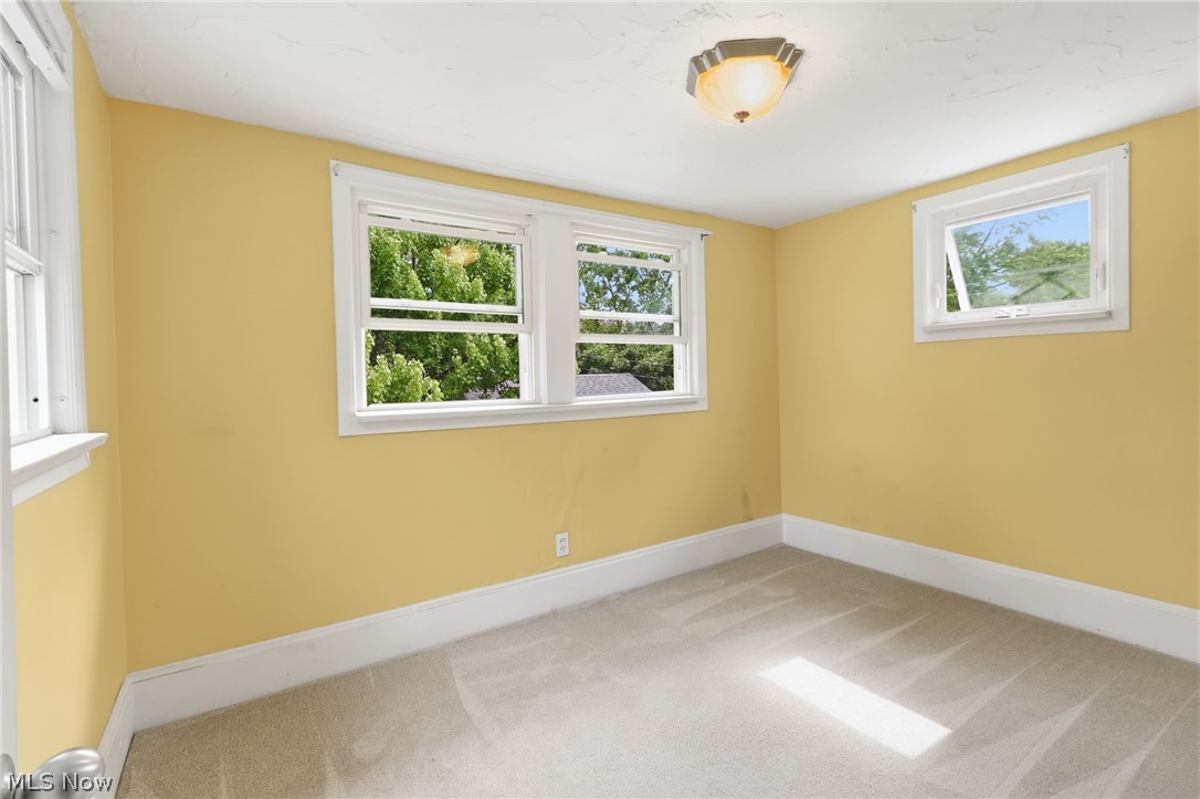 3511 Northcliffe Road Cleveland, OH 44118 - Photo 17 of 46 Neutral tone wall finish, white trim, ceiling-mounted light fixture, and carpeting