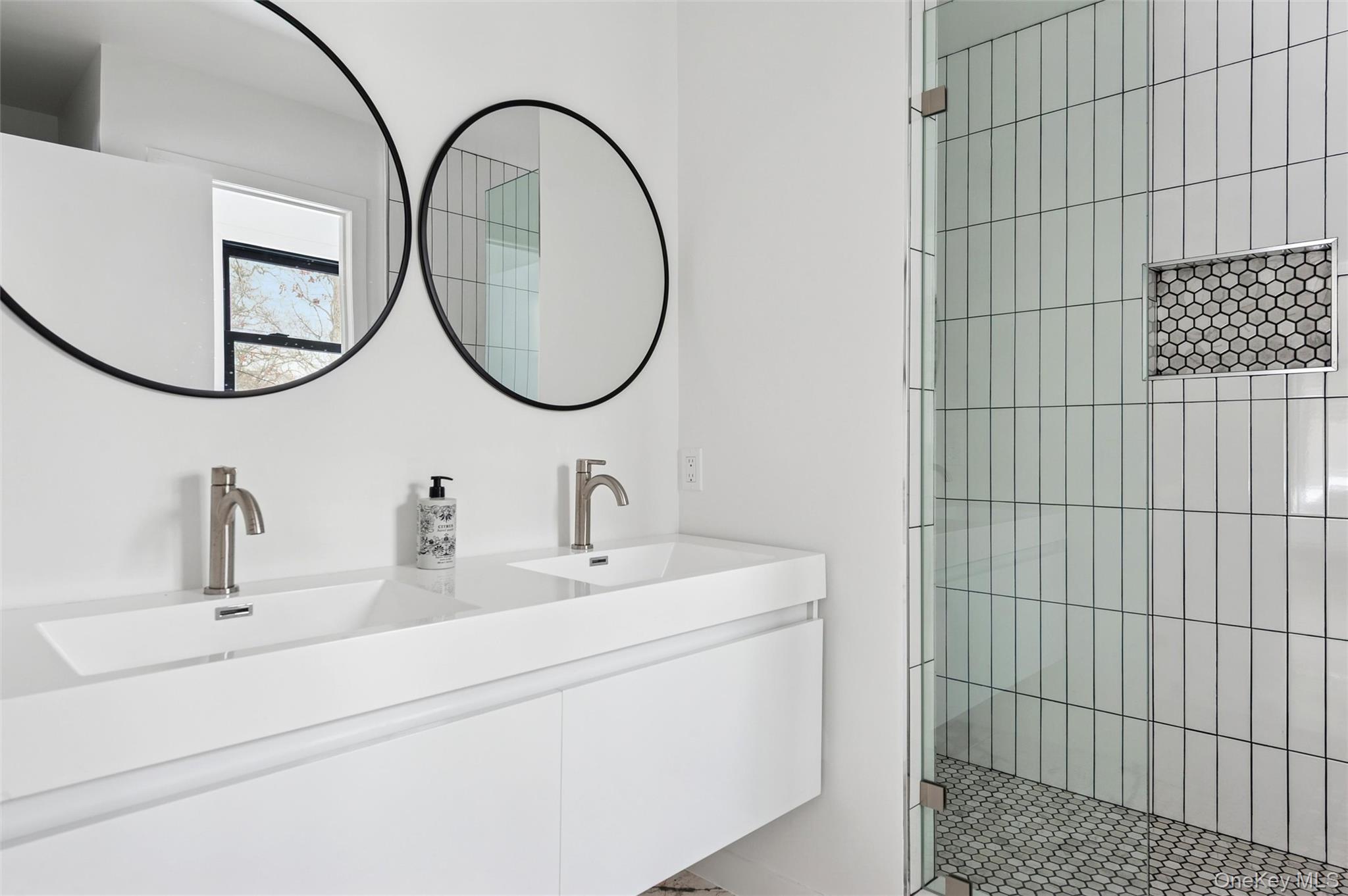 10 Hampton Street Westhampton Beach, NY 11978 - Photo 11 of 25 a bathroom with a sink and a mirror