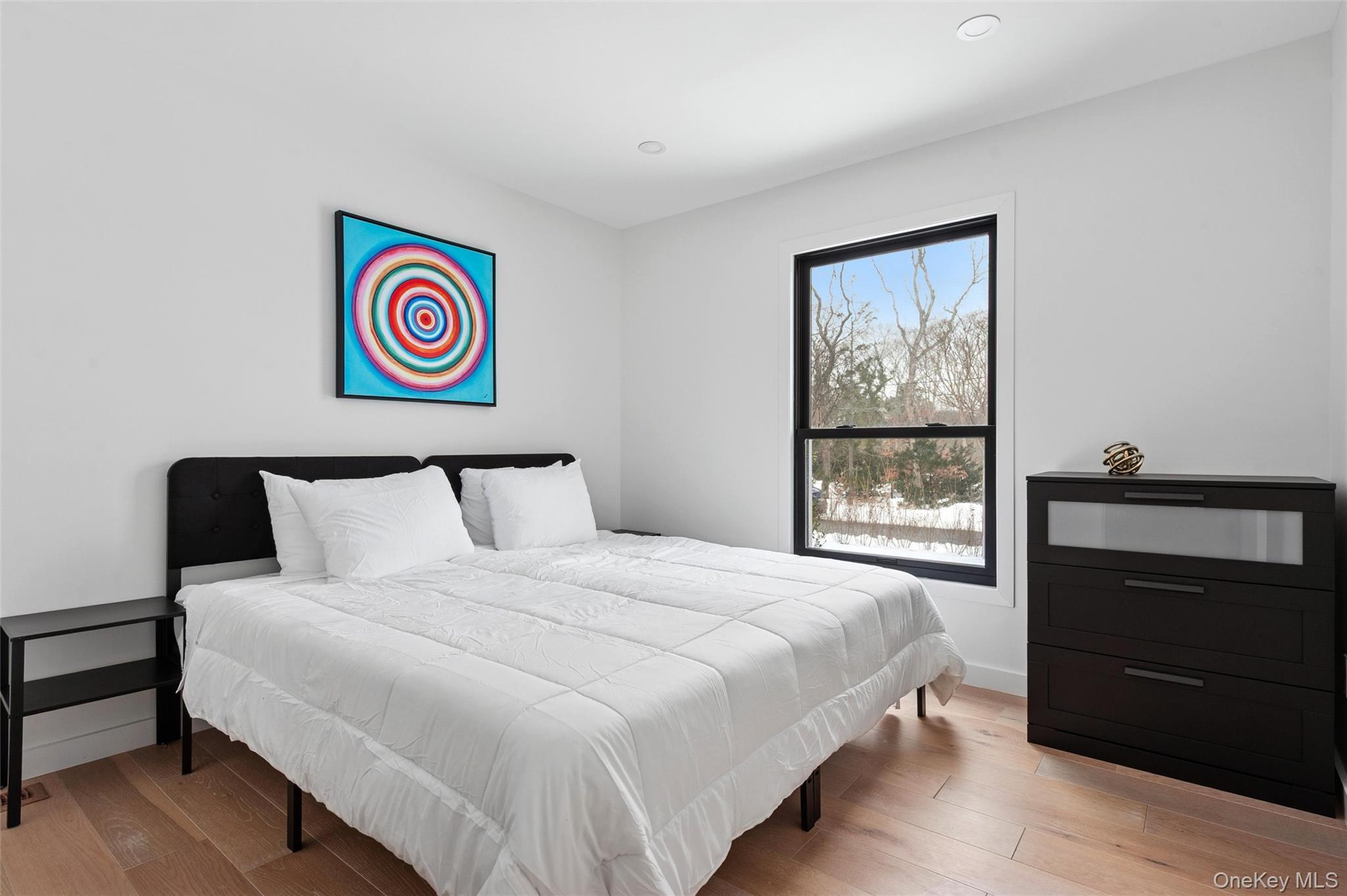 10 Hampton Street Westhampton Beach, NY 11978 - Photo 13 of 25 a bedroom with a bed and a window