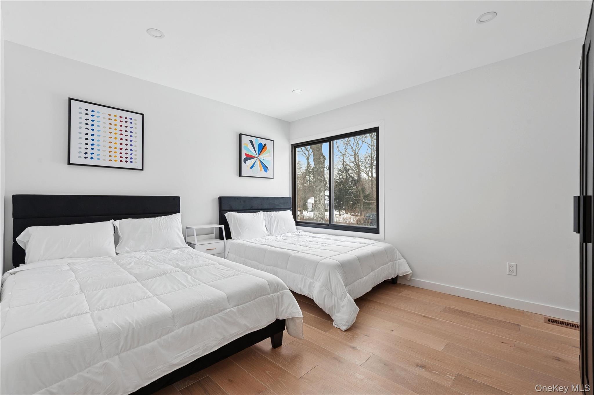 10 Hampton Street Westhampton Beach, NY 11978 - Photo 15 of 25 a bedroom with two beds and a window