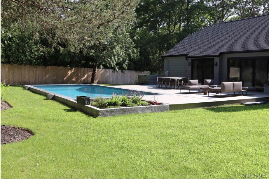 10 Hampton Street Westhampton Beach, NY 11978 - Photo 2 of 25 a view of swimming pool with lawn chairs and plants