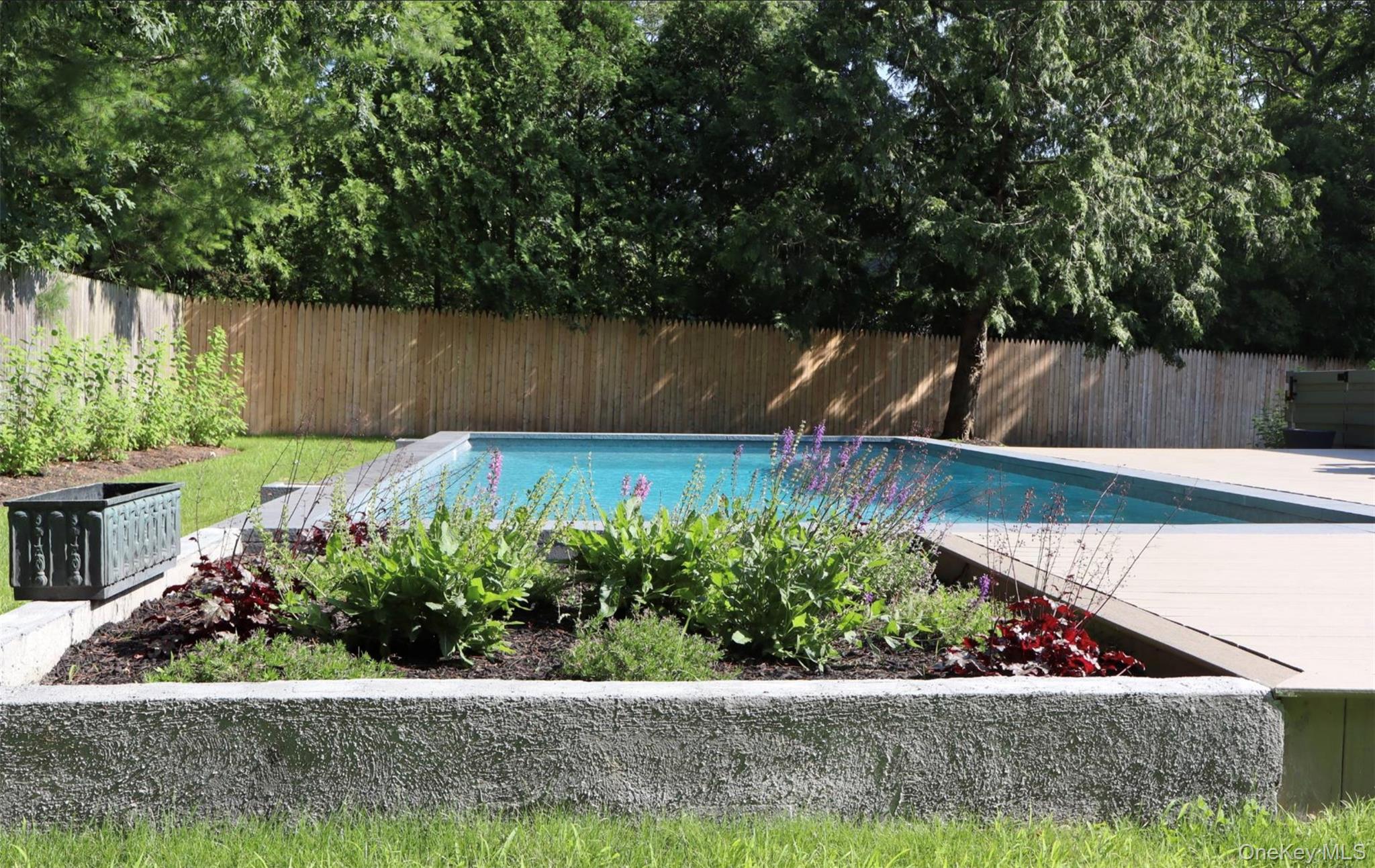 10 Hampton Street Westhampton Beach, NY 11978 - Photo 21 of 25 a view of a garden with wooden fence