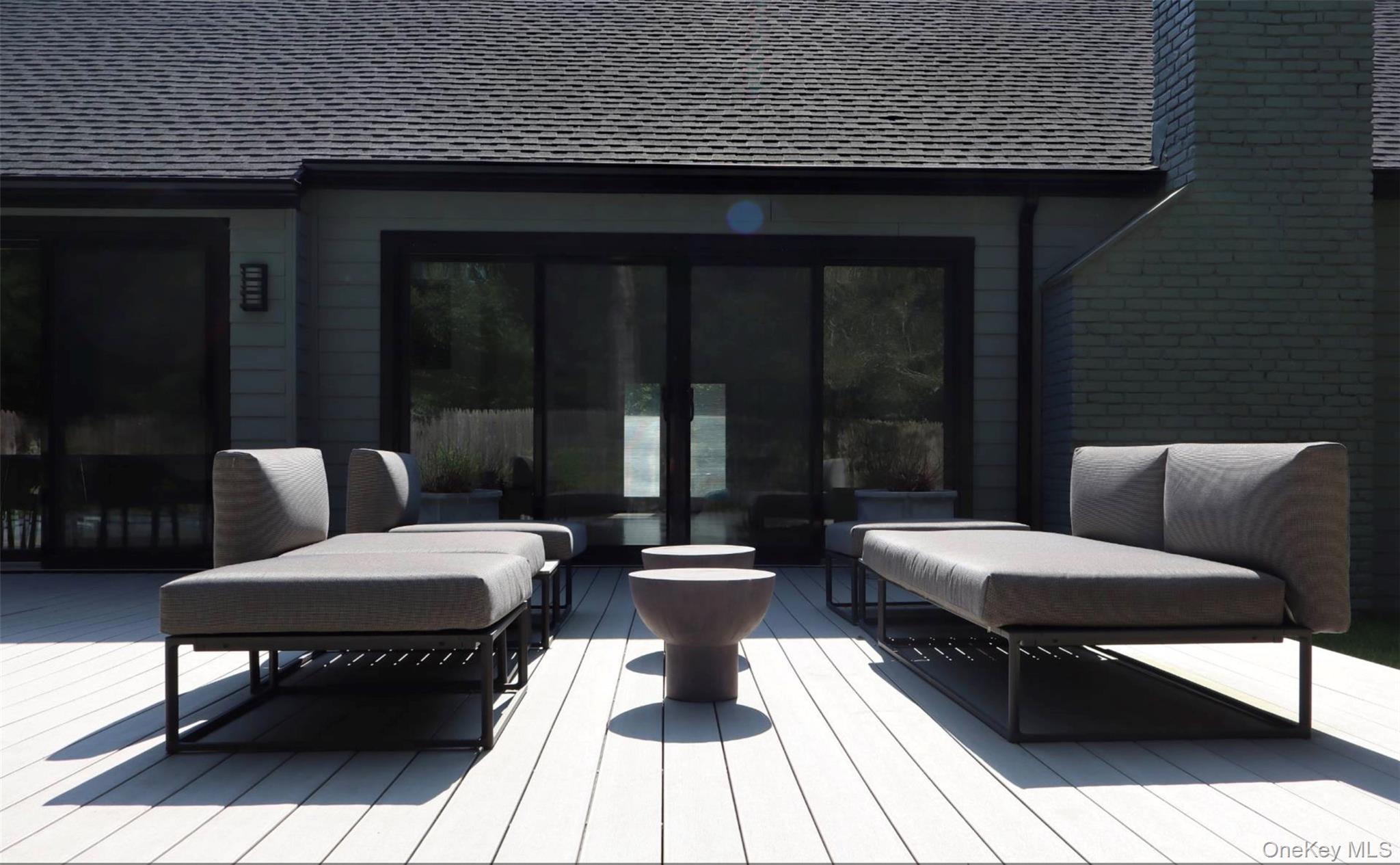 10 Hampton Street Westhampton Beach, NY 11978 - Photo 23 of 25 a view of a patio with couple of chairs and a potted plant