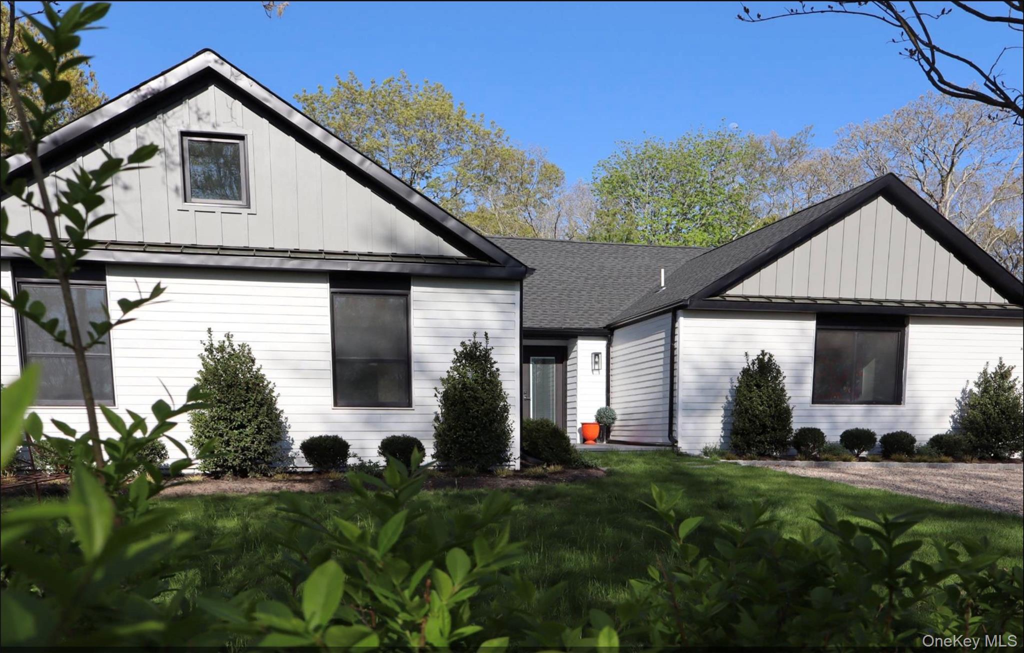 10 Hampton Street Westhampton Beach, NY 11978 - Photo 24 of 25 a front view of a house with a yard and garage
