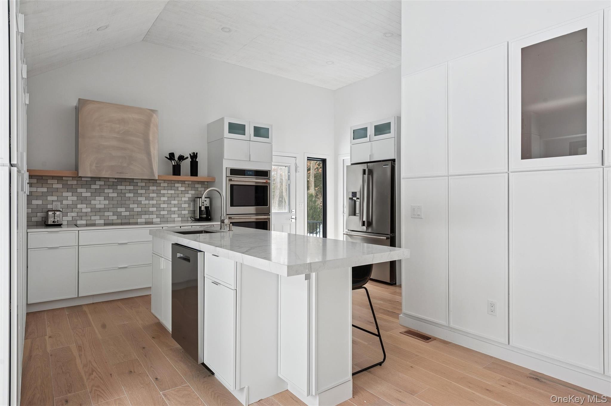 10 Hampton Street Westhampton Beach, NY 11978 - Photo 8 of 25 a kitchen with cabinets and chairs