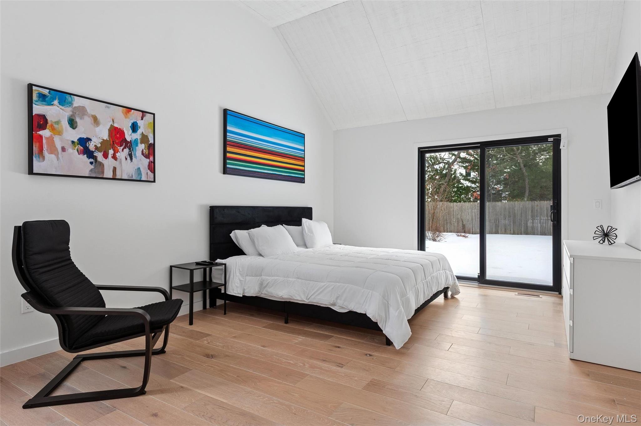 10 Hampton Street Westhampton Beach, NY 11978 - Photo 10 of 25 a spacious bedroom with a bed and a desk