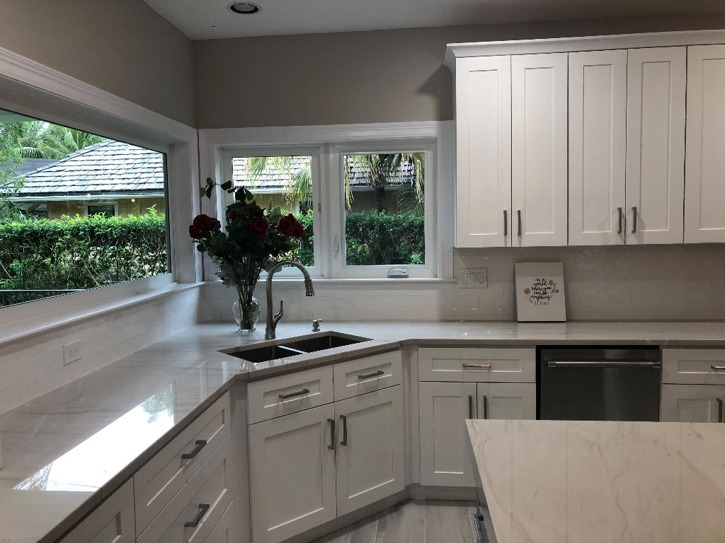 18169 Southeast Ridgeview Drive Tequesta, FL 33469 - Photo 11 of 23 a kitchen with white cabinets and a window
