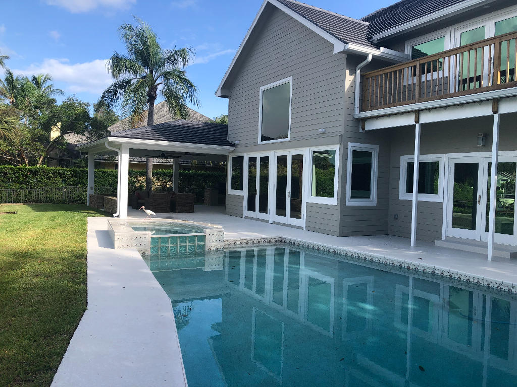 18169 Southeast Ridgeview Drive Tequesta, FL 33469 - Photo 18 of 23 front view of house with a yard
