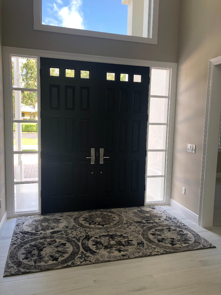 18169 Southeast Ridgeview Drive Tequesta, FL 33469 - Photo 3 of 23 a view of a wooden door and entryway