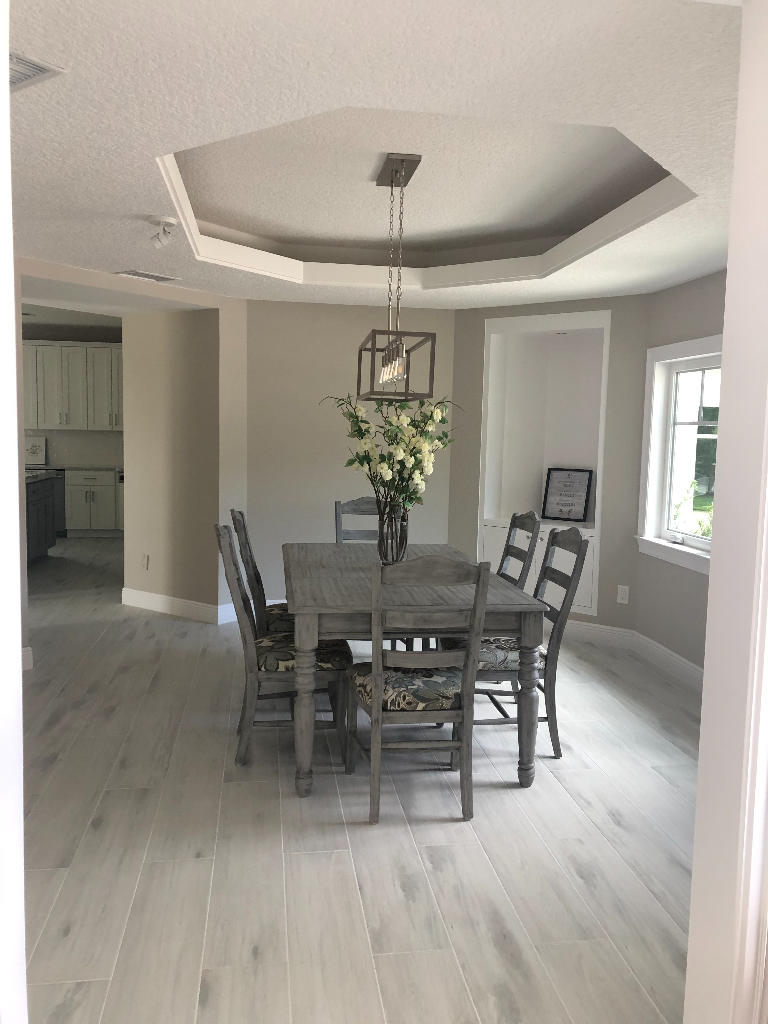 18169 Southeast Ridgeview Drive Tequesta, FL 33469 - Photo 7 of 23 a view of a dining room with furniture and chandelier