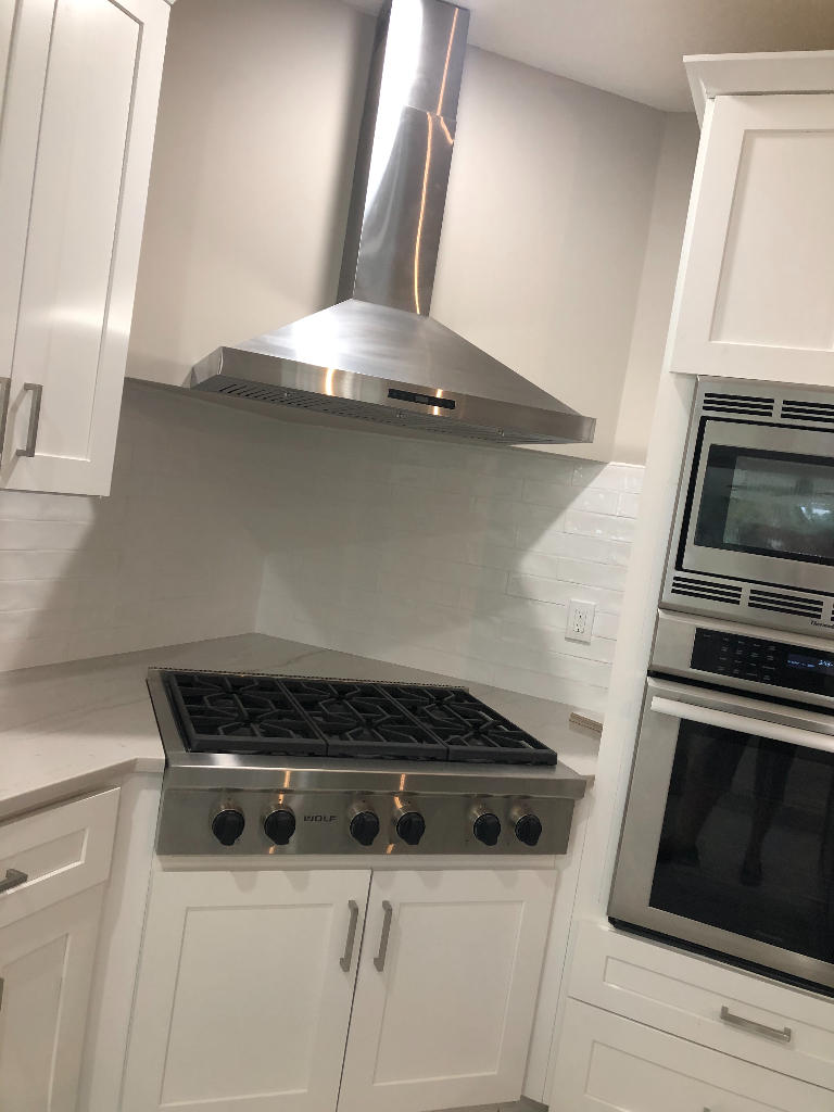 18169 Southeast Ridgeview Drive Tequesta, FL 33469 - Photo 10 of 23 a stove top oven sitting inside of a kitchen