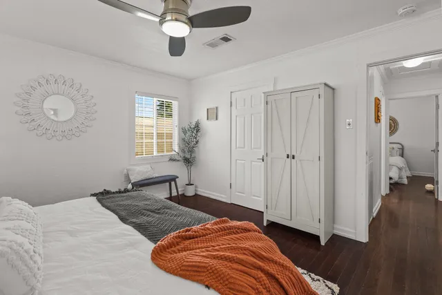 a view of an empty room with wooden floor