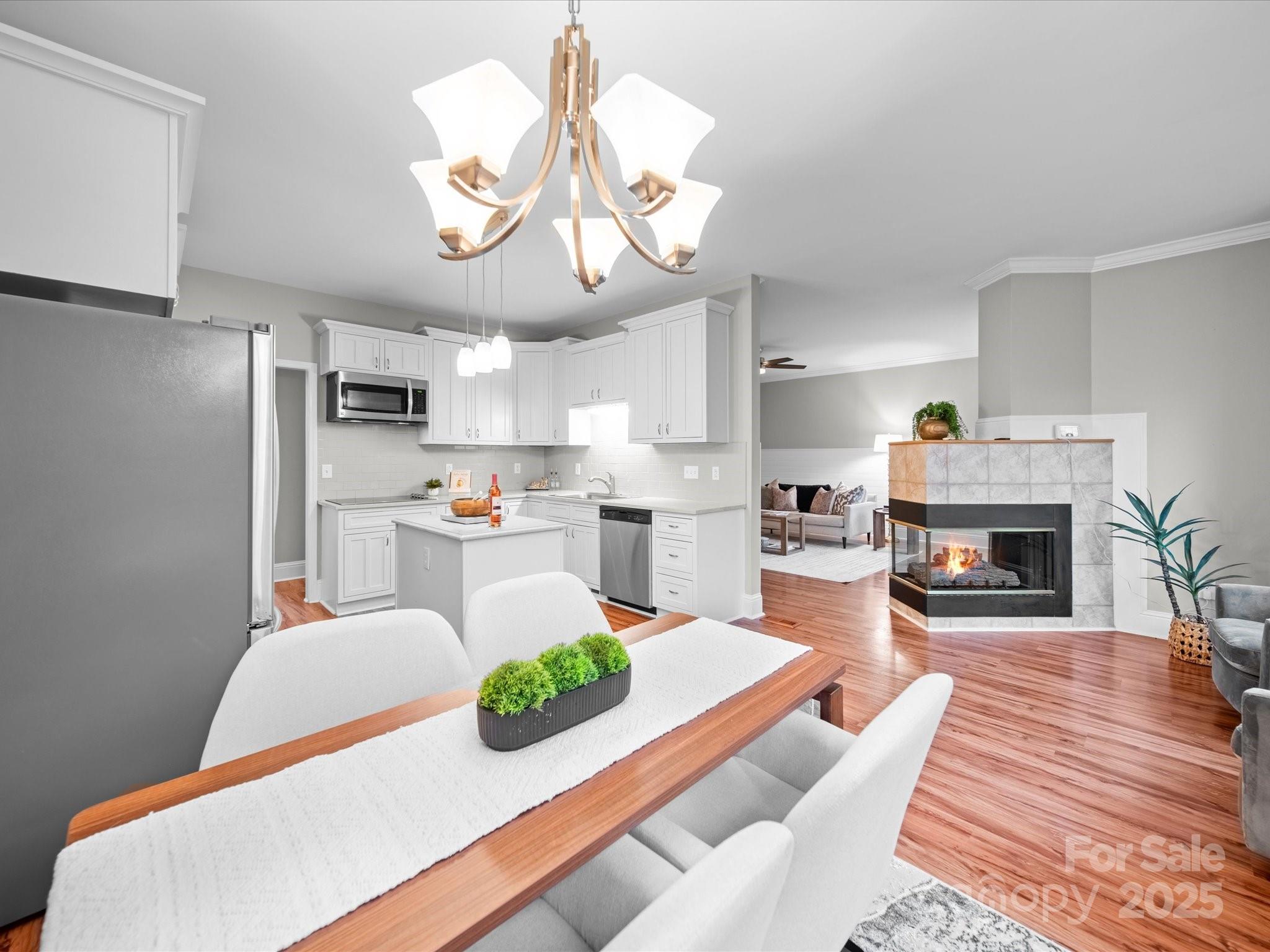 209 Chesterfield Canal Fort Mill, SC 29708 - Photo 21 of 24 a living room with fireplace furniture and a chandelier