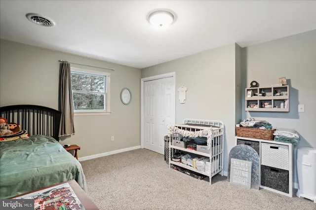 a bedroom with furniture and a baby crib