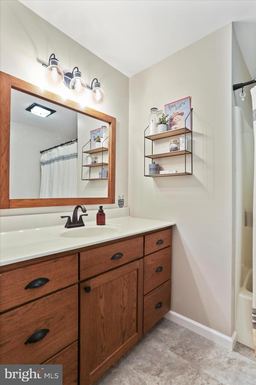 4747 Church Road Chambersburg, PA 17202 - Photo 20 of 49 a bathroom with a sink a mirror and a window