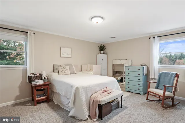 a bedroom with a bed and a chair