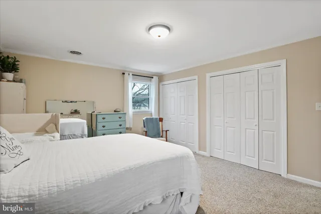 a bedroom with double bed and a window