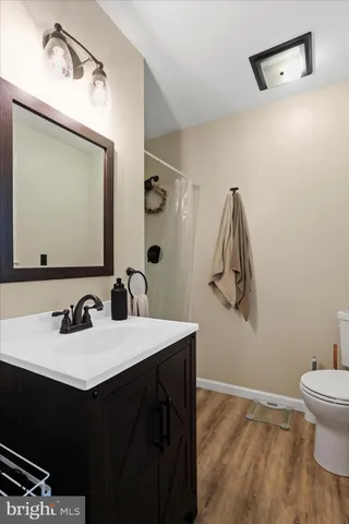 a bathroom with a sink vanity and a mirror