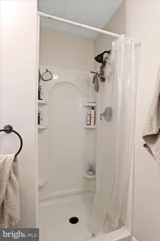 a bathroom with a glass shower door