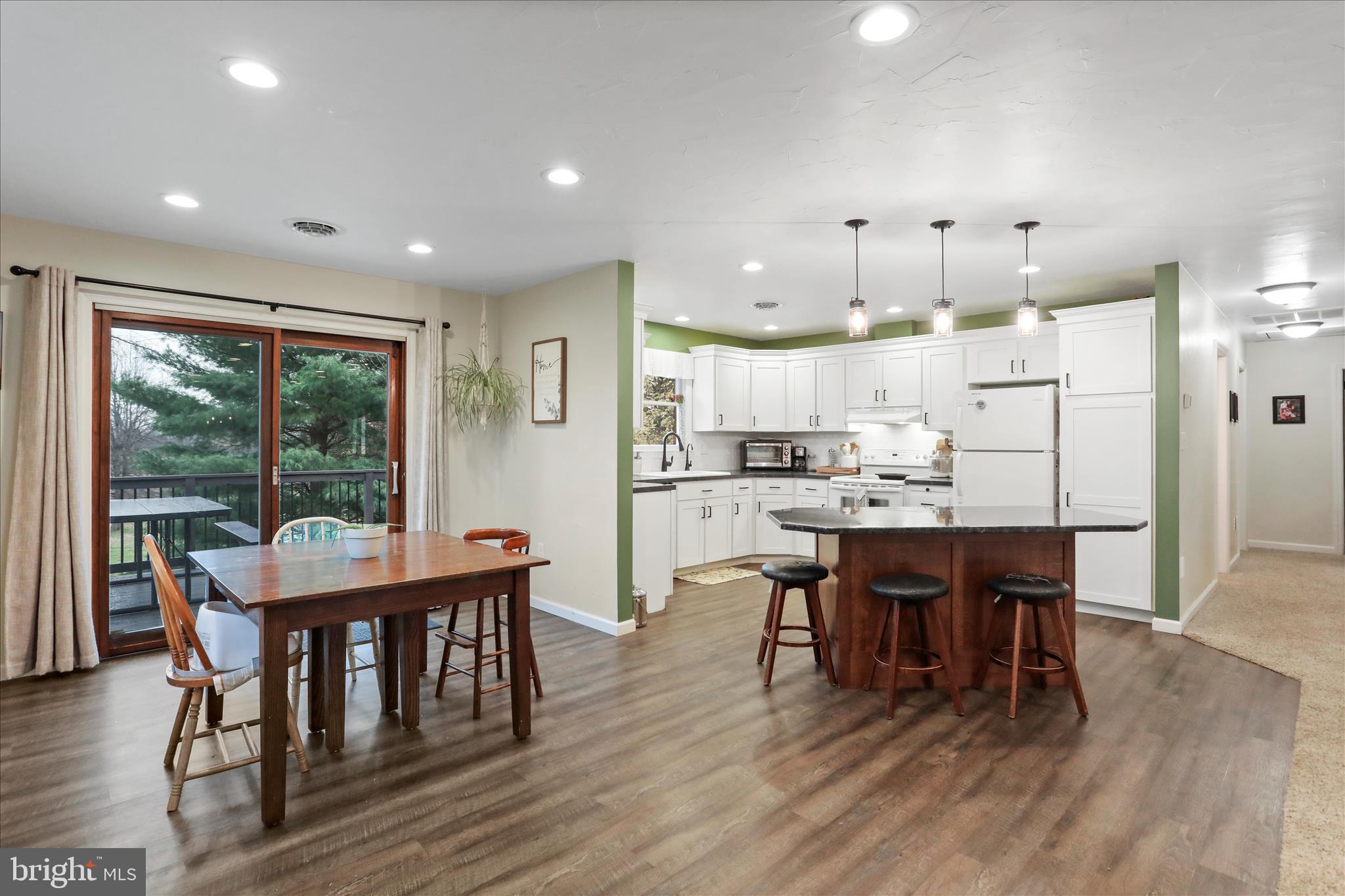 4747 Church Road Chambersburg, PA 17202 - Photo 7 of 49 a dining room with stainless steel appliances wooden floors a table and chairs