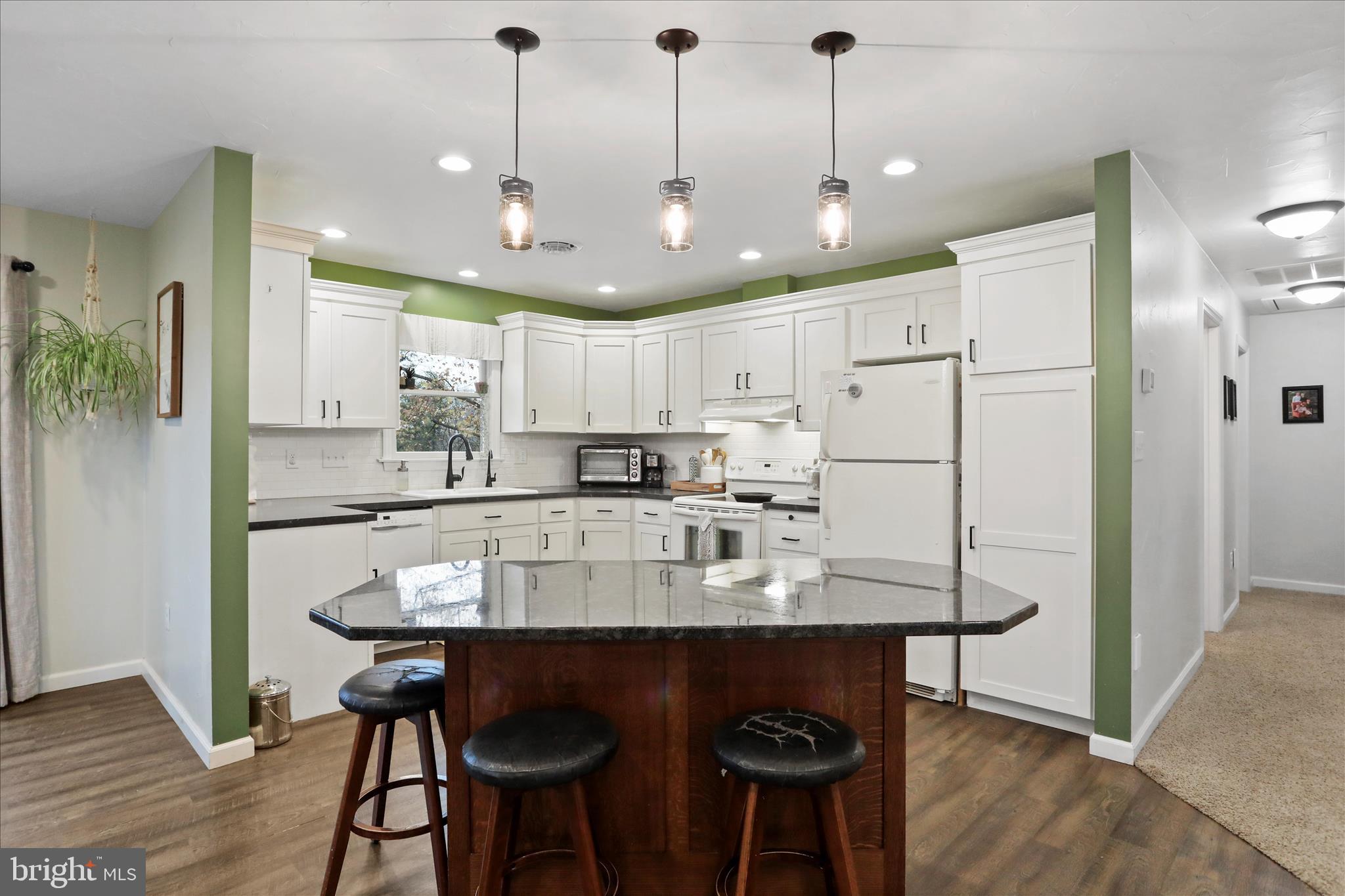 4747 Church Road Chambersburg, PA 17202 - Photo 9 of 49 a kitchen with stainless steel appliances kitchen island granite countertop a dining table chairs and sink