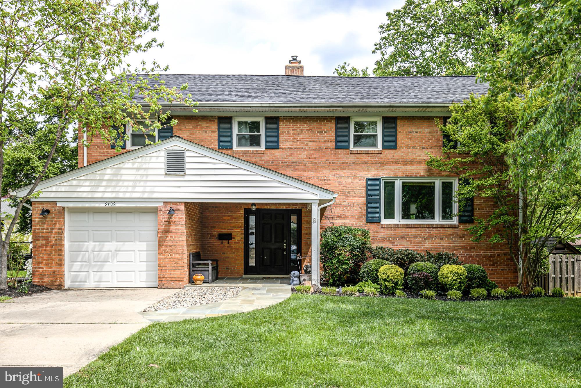 6409 Crane Terrace Bethesda, MD 20817 - Photo 1 of 59 a front view of a house with a garden