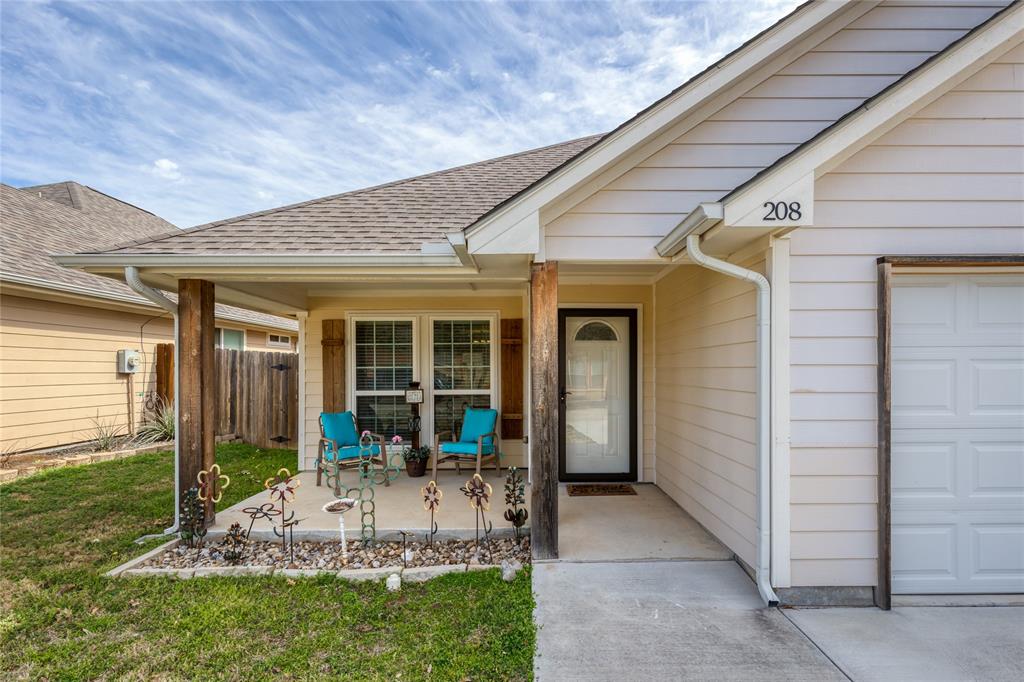 a view of a house with backyard sitting area and porch