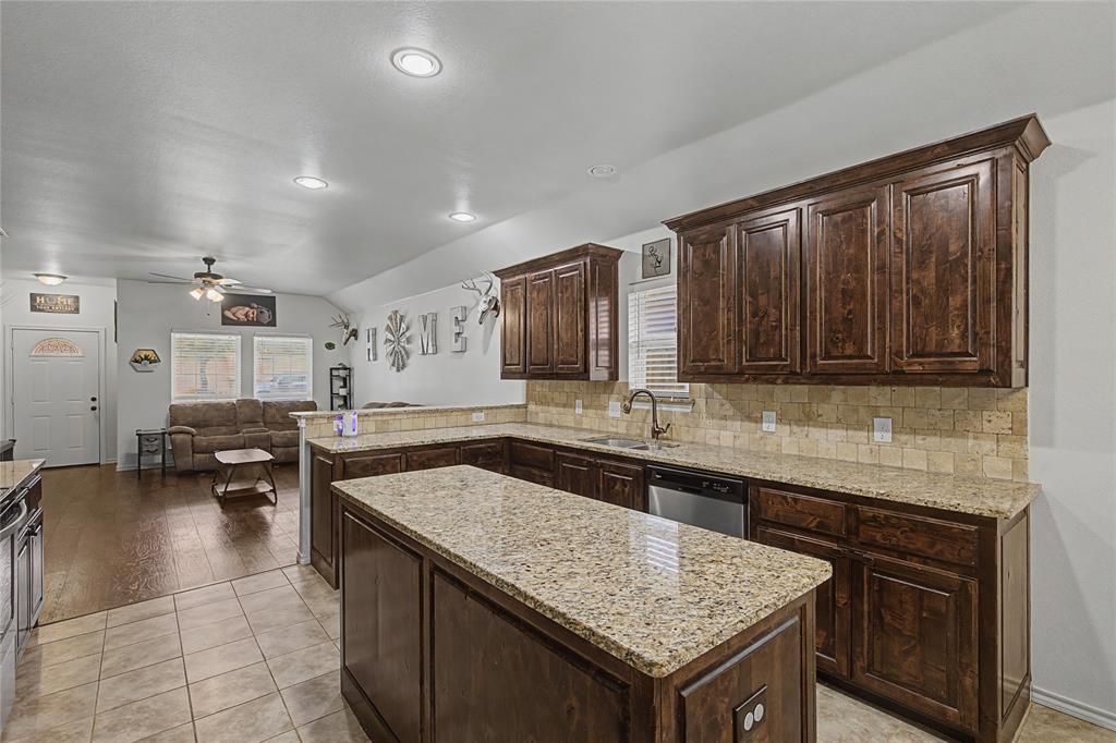 208 Lovers Path Drive Springtown, TX 76082 - Photo 11 of 35 a kitchen with a stove sink and cabinets