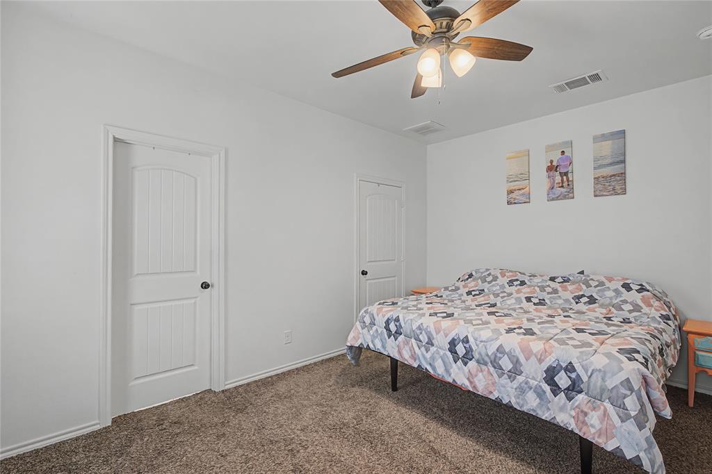 208 Lovers Path Drive Springtown, TX 76082 - Photo 21 of 35 a bedroom with a bed and a ceiling fan